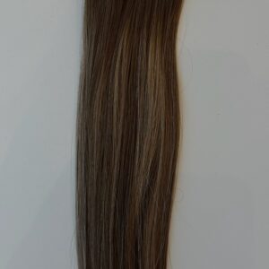Shelby is a section of straight, medium brown hair extensions with subtle lighter highlights, shown against a plain light background.
