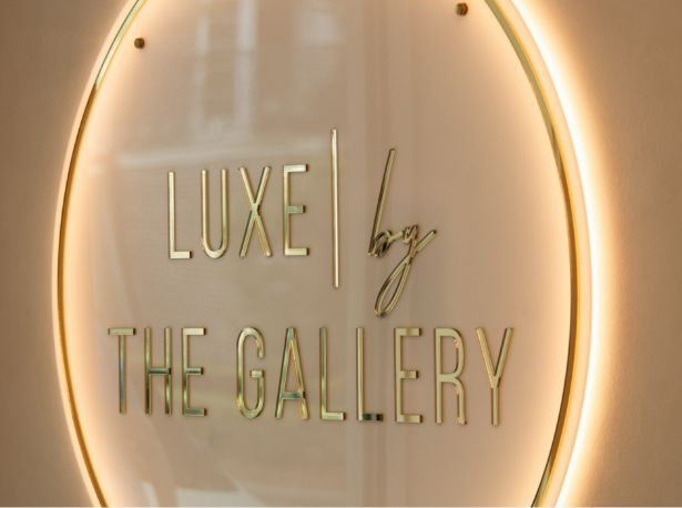 Luxe by the Gallery sign for a boutique salon, featuring elegant typography and a stylish design.